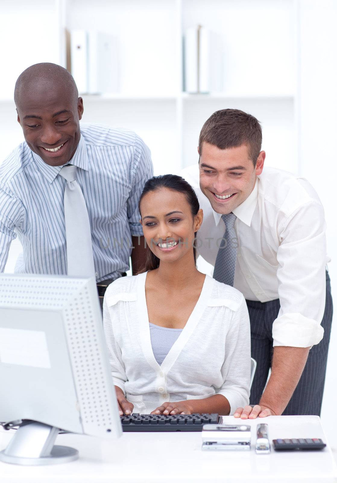 Two businessmen and businesswoman working together in office