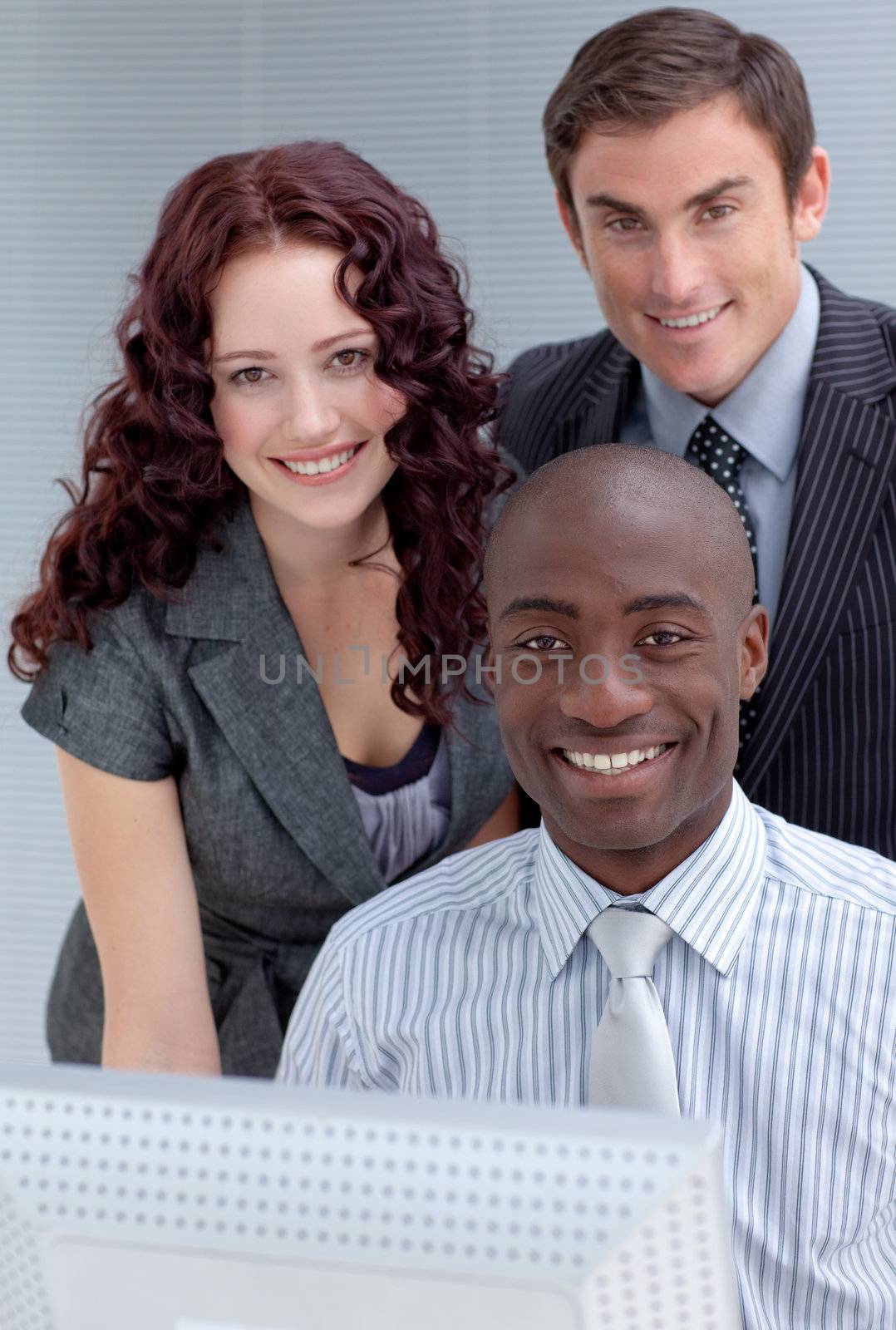 Businessmen and businesswoman with a computer by Wavebreakmedia