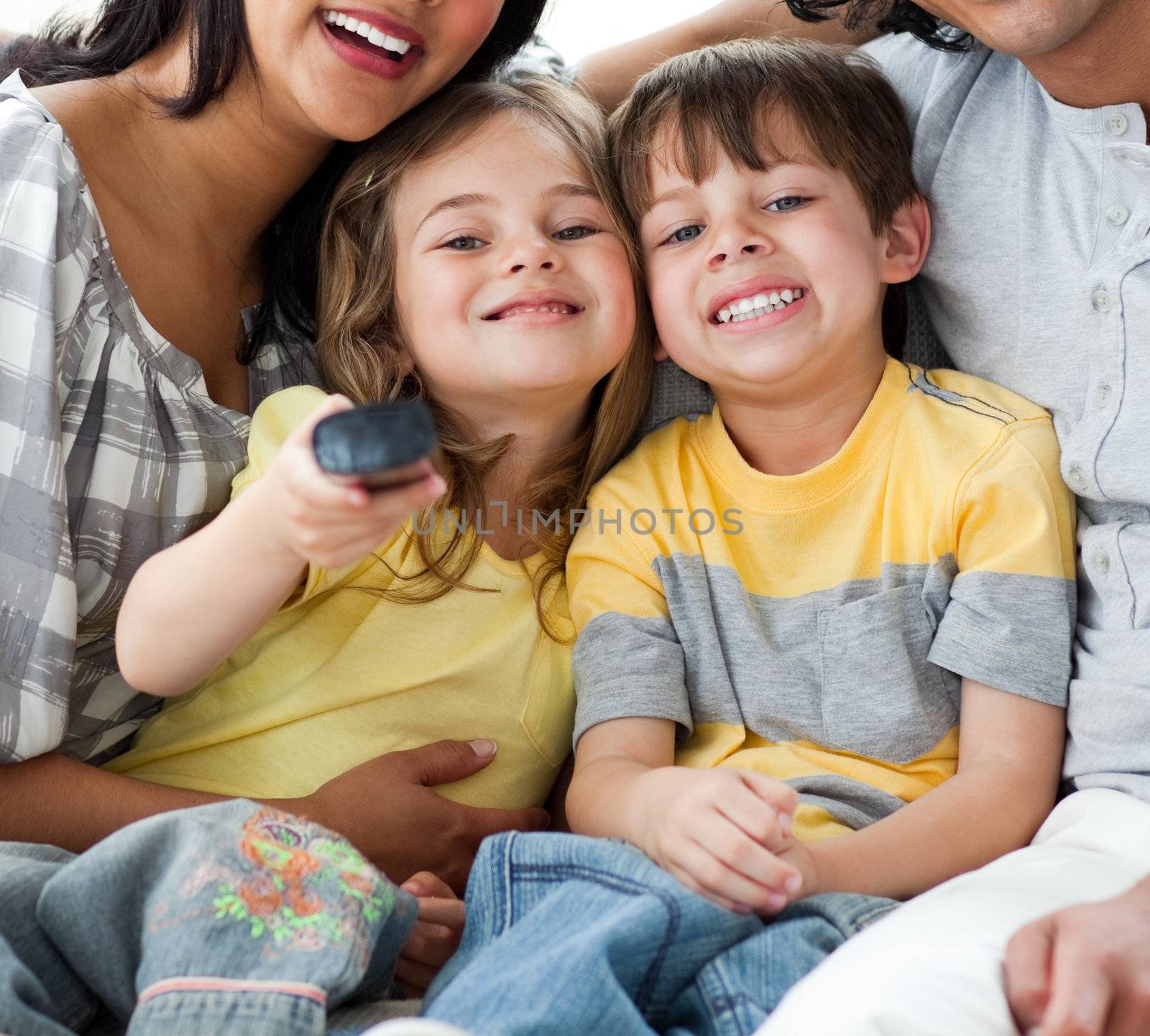 Cute children watching TV with their parents  by Wavebreakmedia