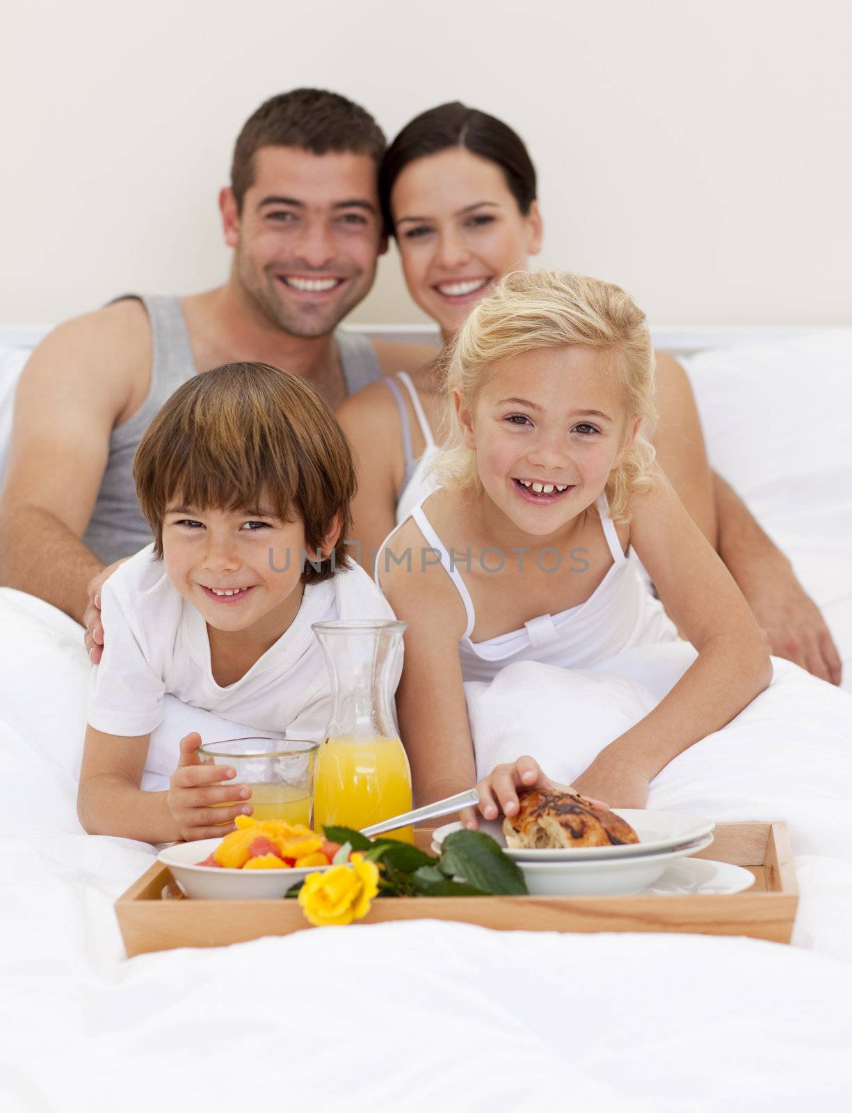 Family having breakfast in bedroom by Wavebreakmedia