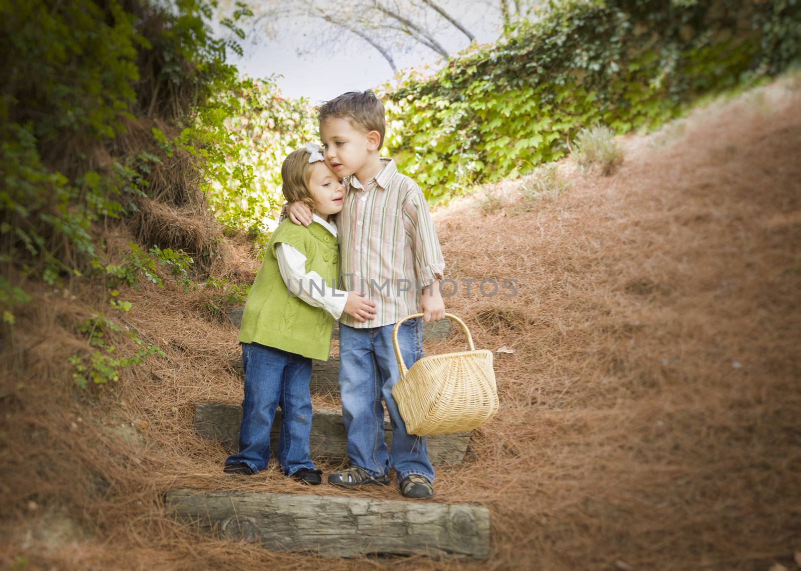 Two Children with Basket Hugging Outside on Steps by Feverpitched