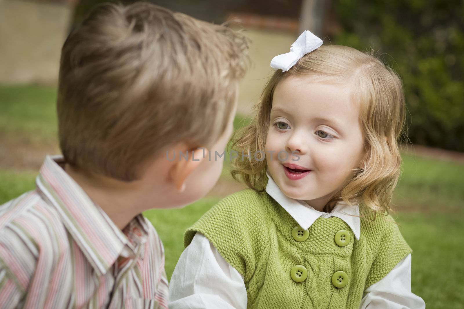 Adorable Brother and Sister Children Playing with Each Other Outside.