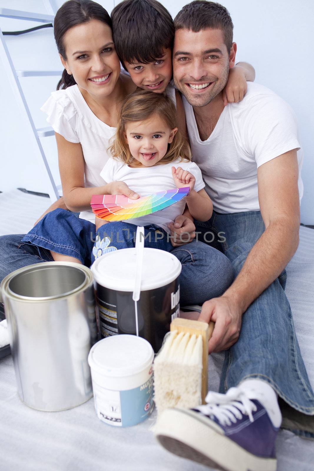 Family with colour samples to paint new house by Wavebreakmedia