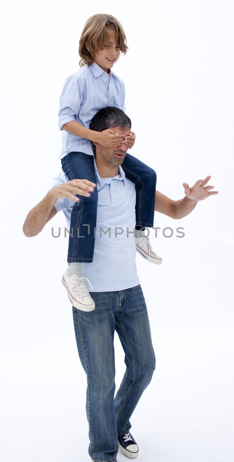 Father giving son piggy back ride with eyes closed against white background
