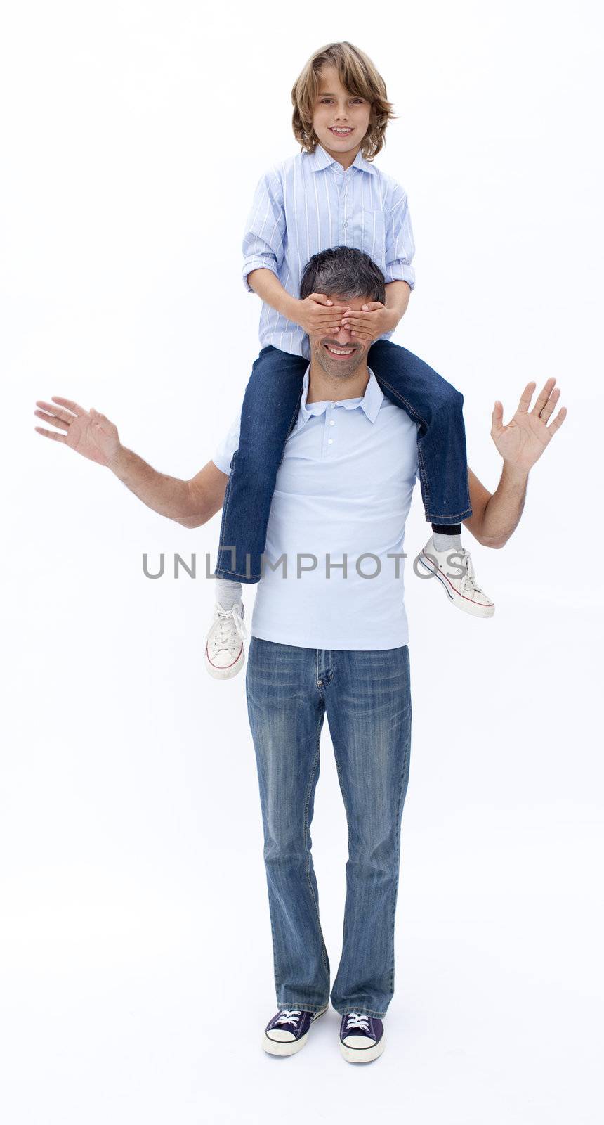 Father giving little boy piggy back ride with eyes closed against white background
