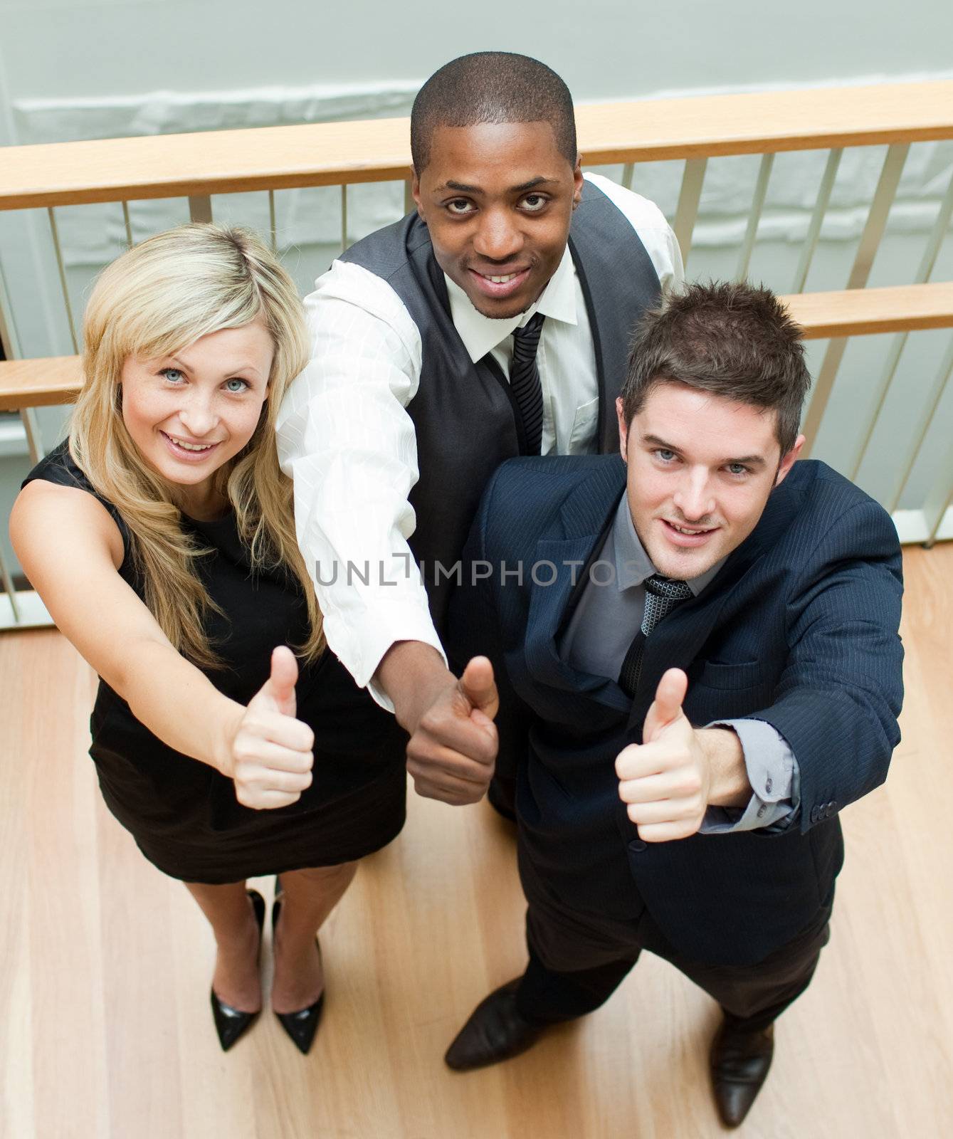 Business people on stairs with thumbs up by Wavebreakmedia