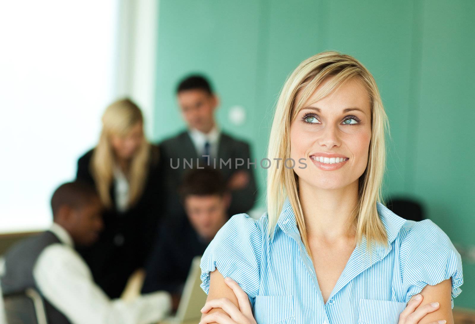 Businesswoman with people at work  by Wavebreakmedia