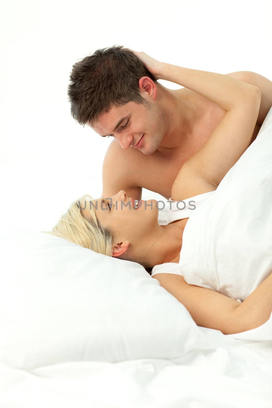 loving Couple relaxing on bed  by Wavebreakmedia