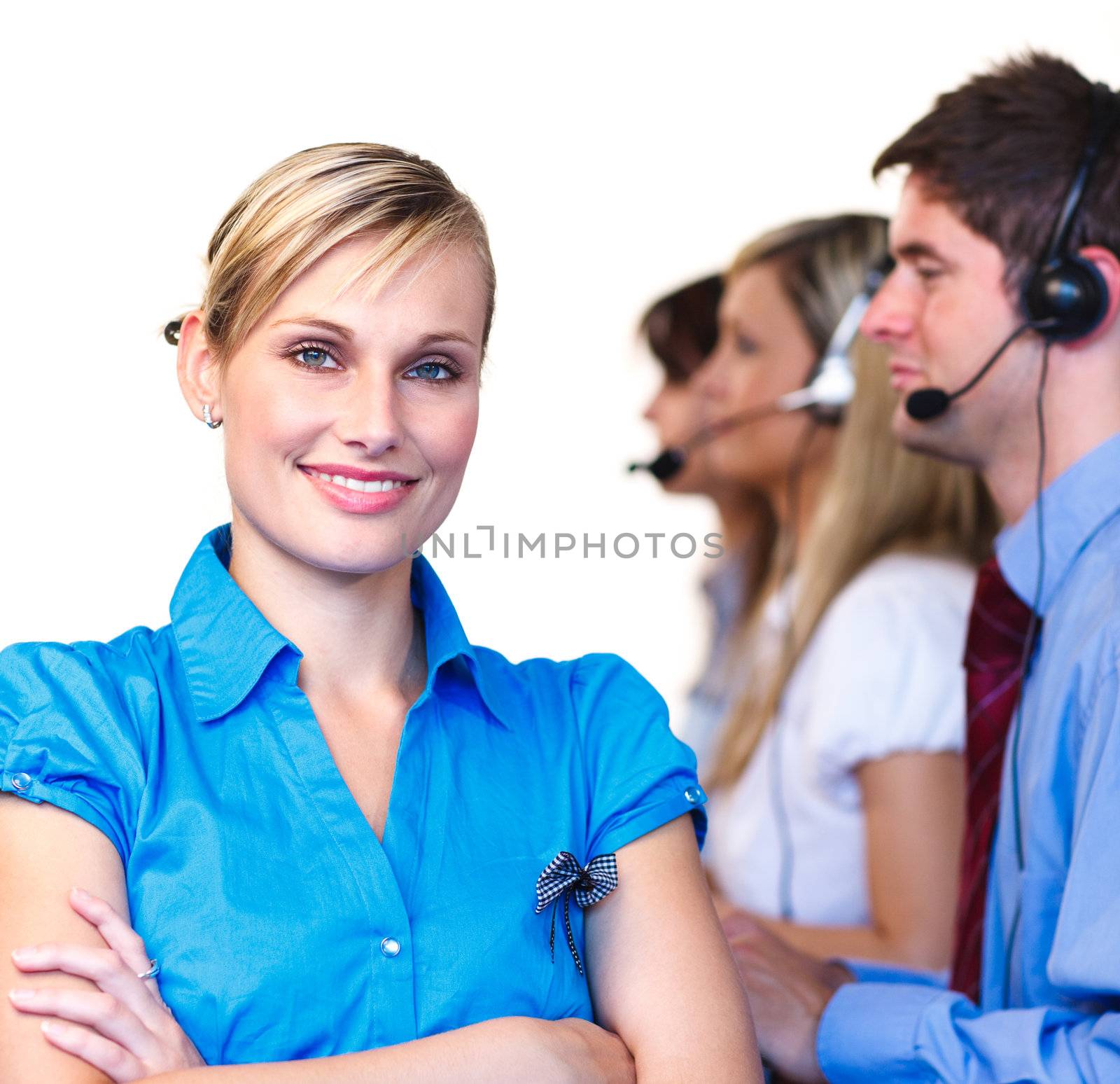 Young businesswoman in front of her team in a call center