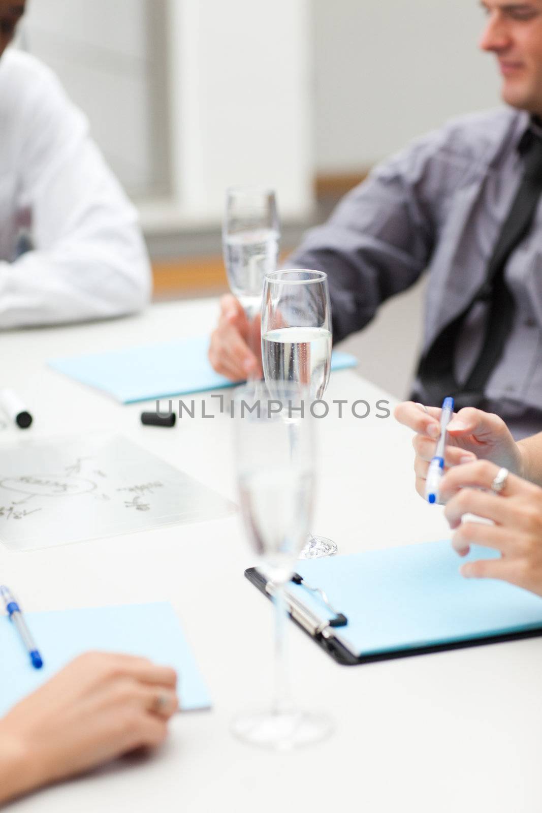 Business people drinking champagne in office by Wavebreakmedia