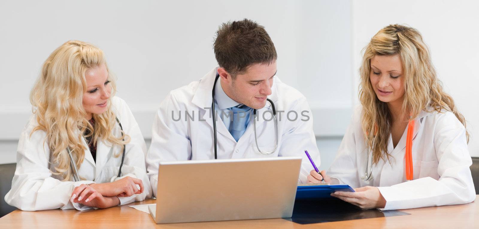 Surgeon team at a meeting by Wavebreakmedia