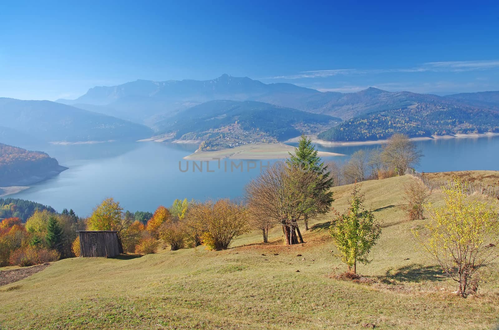 Autumnal landscape with lake and mountains.