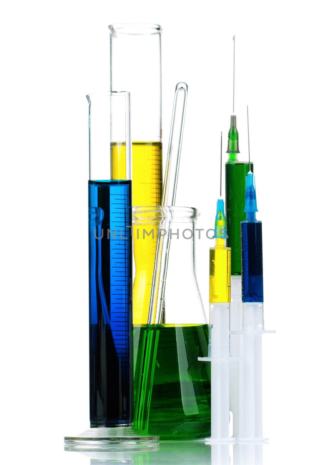 Laboratory glassware with colorful liquids and syringes on white background