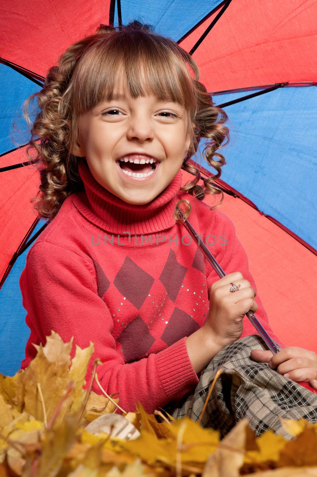 Portrait of a little girl holding an umbrella posing on white
