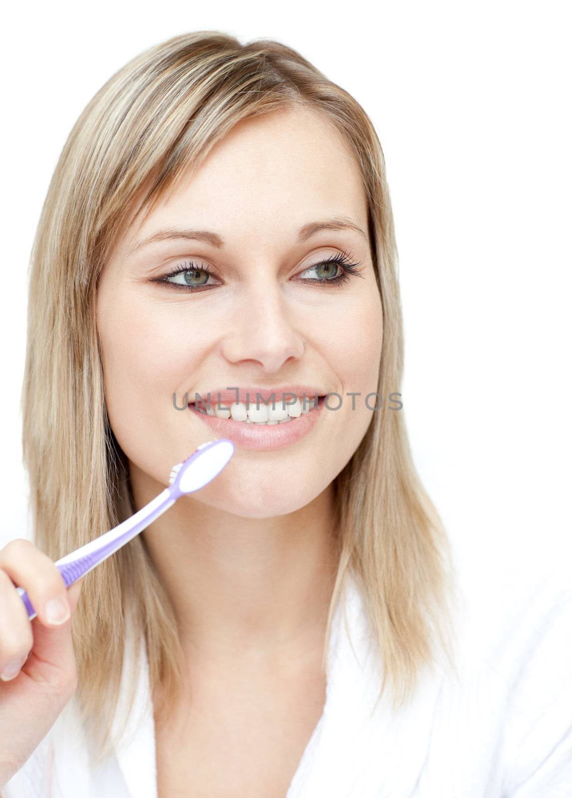 Radiant woman holding a toothbrush against a white background