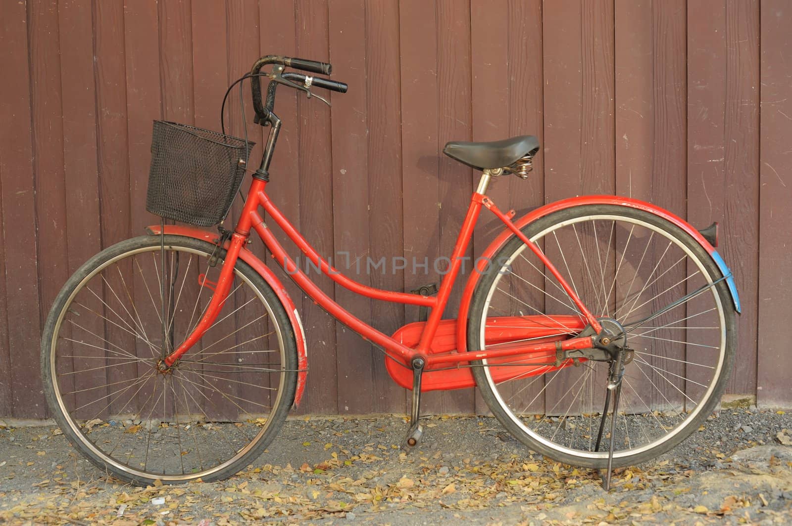 Red old bike at home. by ngungfoto
