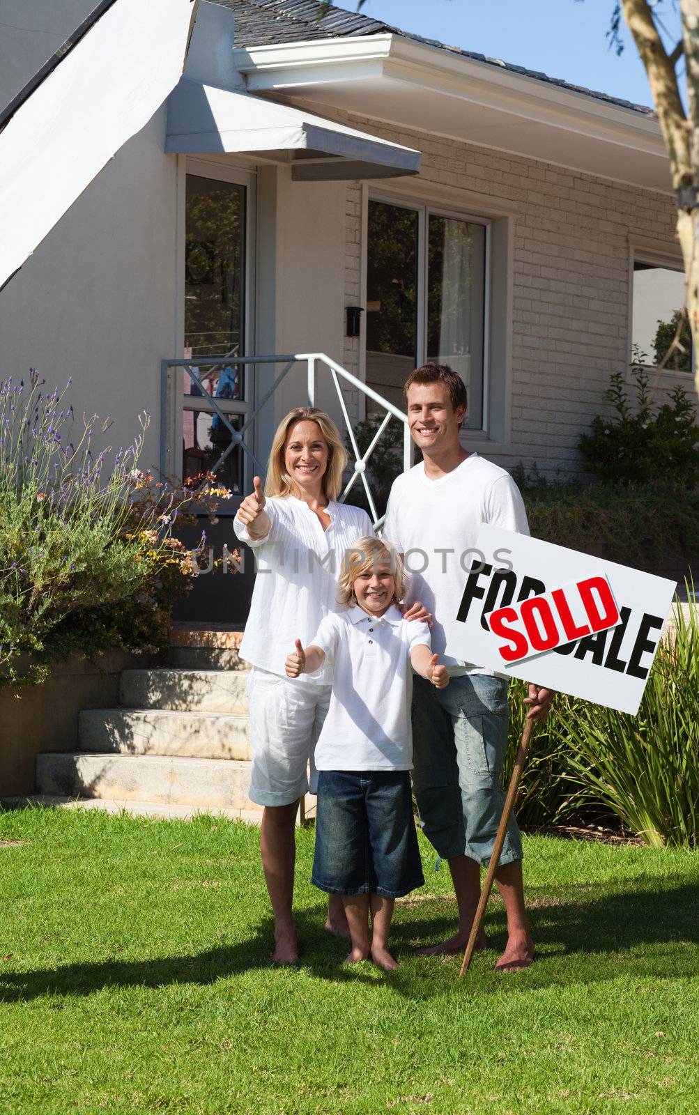 Smiling family with their new home