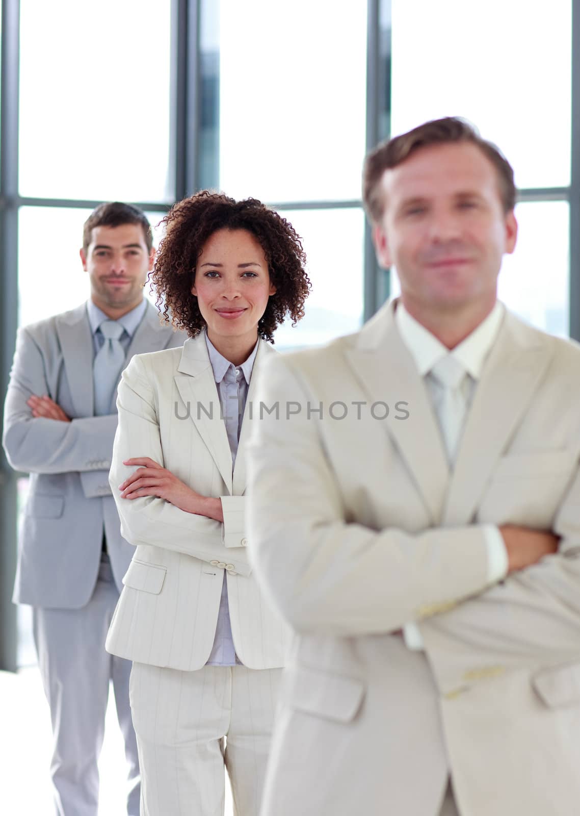 Attractive friendly businesswoman with folded arms in a row
