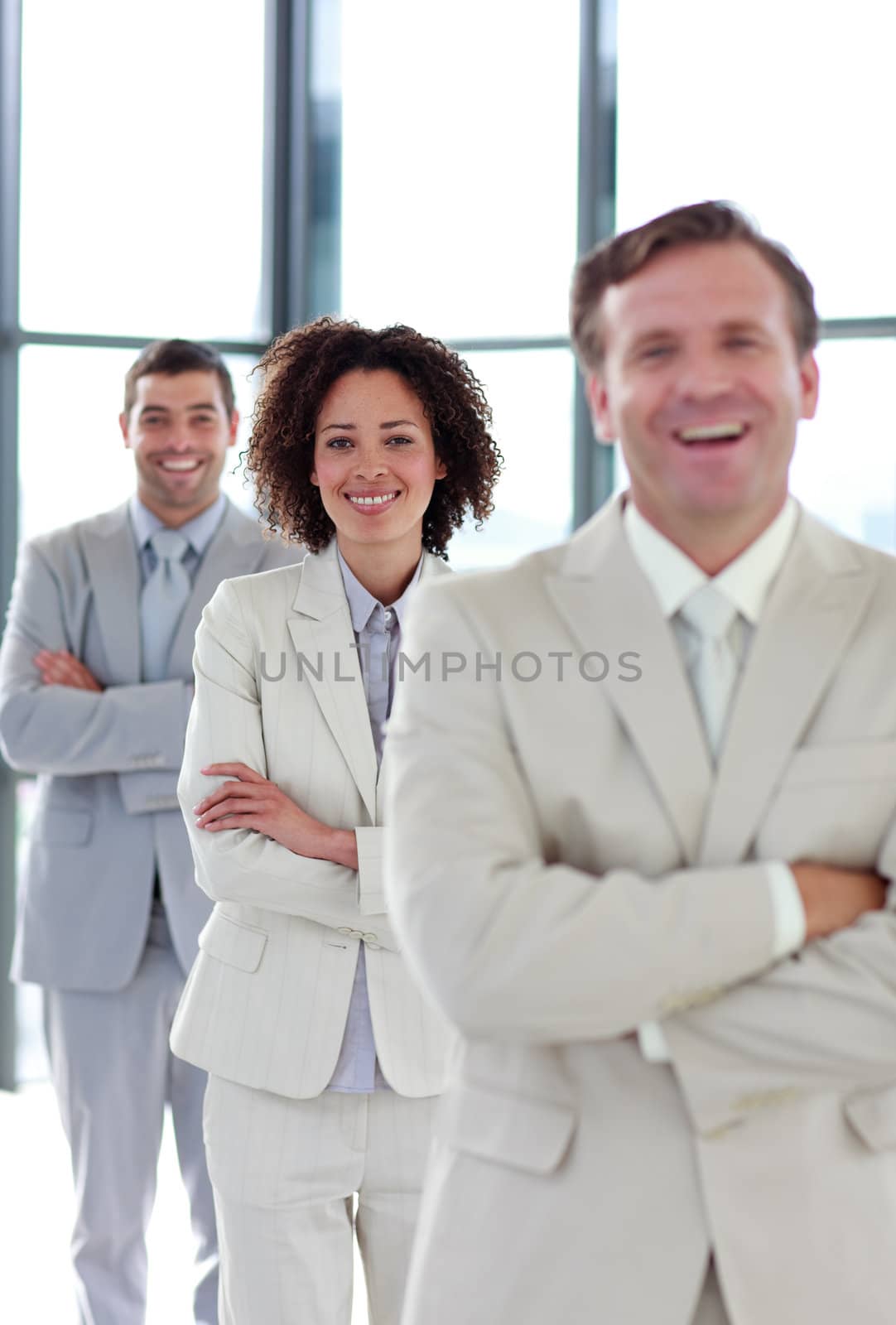 Attractive smiling businesswoman with folded arms in a line