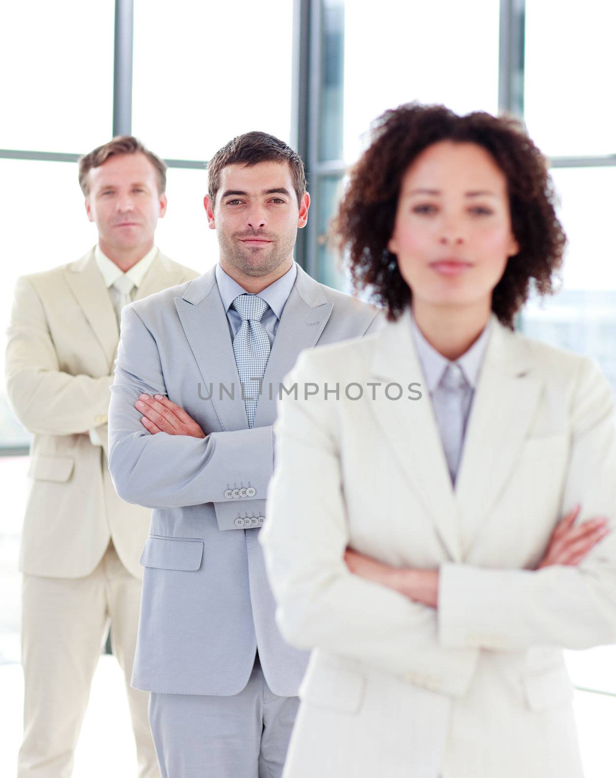 Serious businessman with folded arms in a line by Wavebreakmedia
