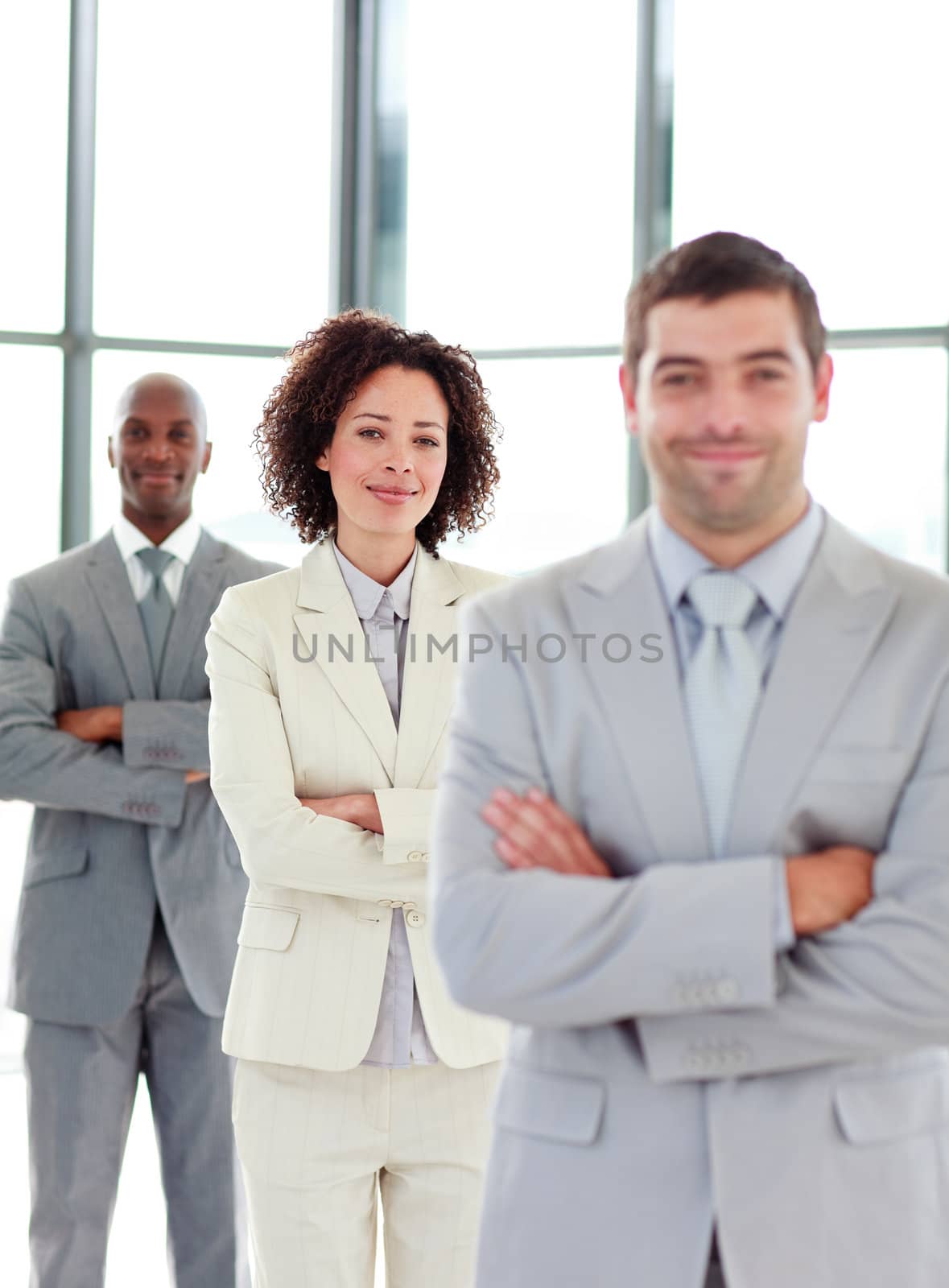 Frinedly young businesswoman with folded arms in a line