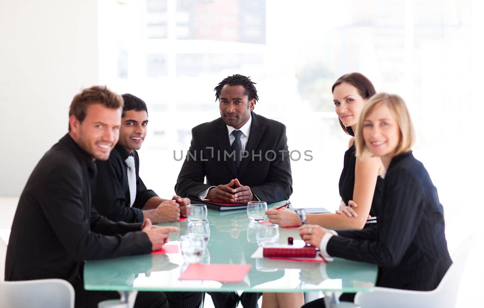 Business people in a meeting looking at the camera