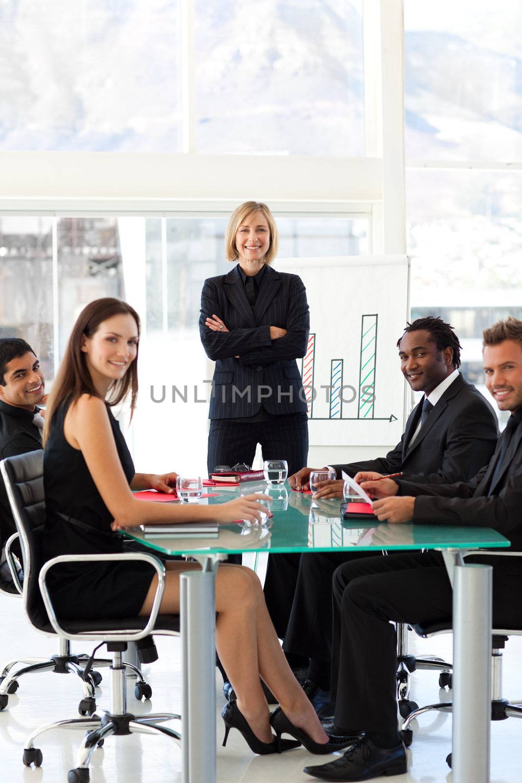 International business people smiling at the camera in a meeting
