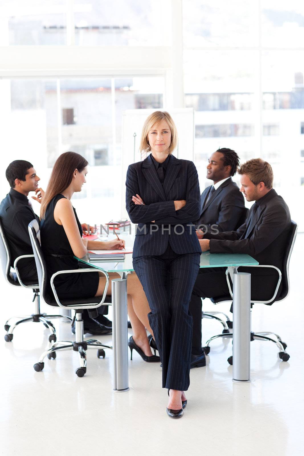 Serious female manager looking at the camera with folded arms