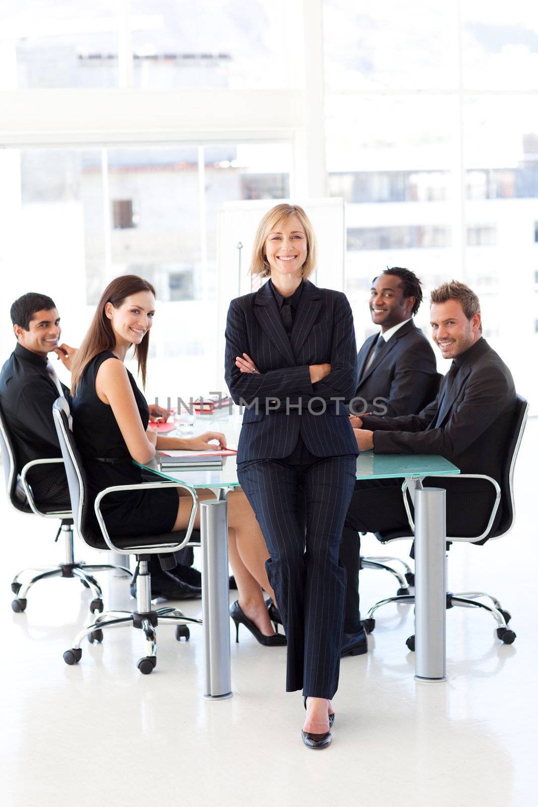 Multi-ethnic business team smiling at the camera in a meeting