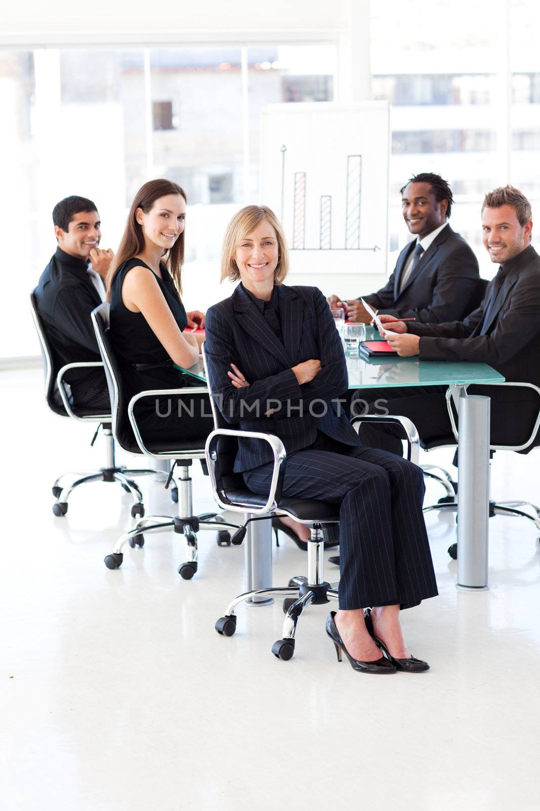 Smiling multi-ethnic business team sitting in a presentation