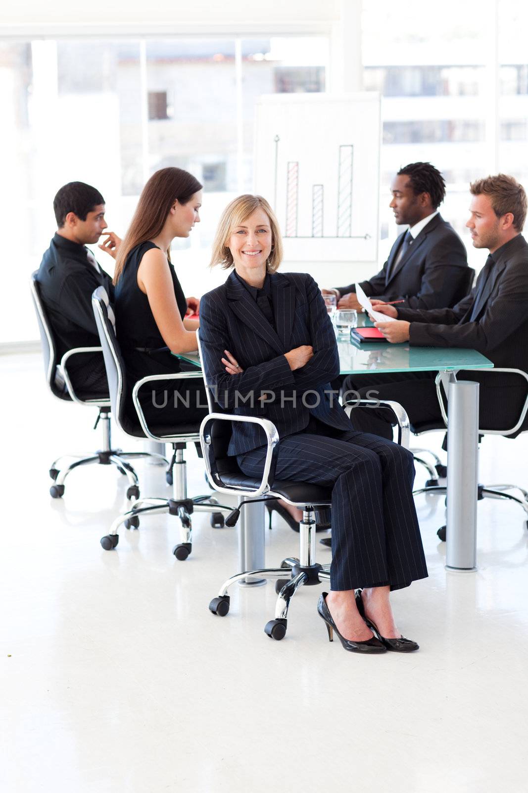 Smiling female manager sitting in a meeting