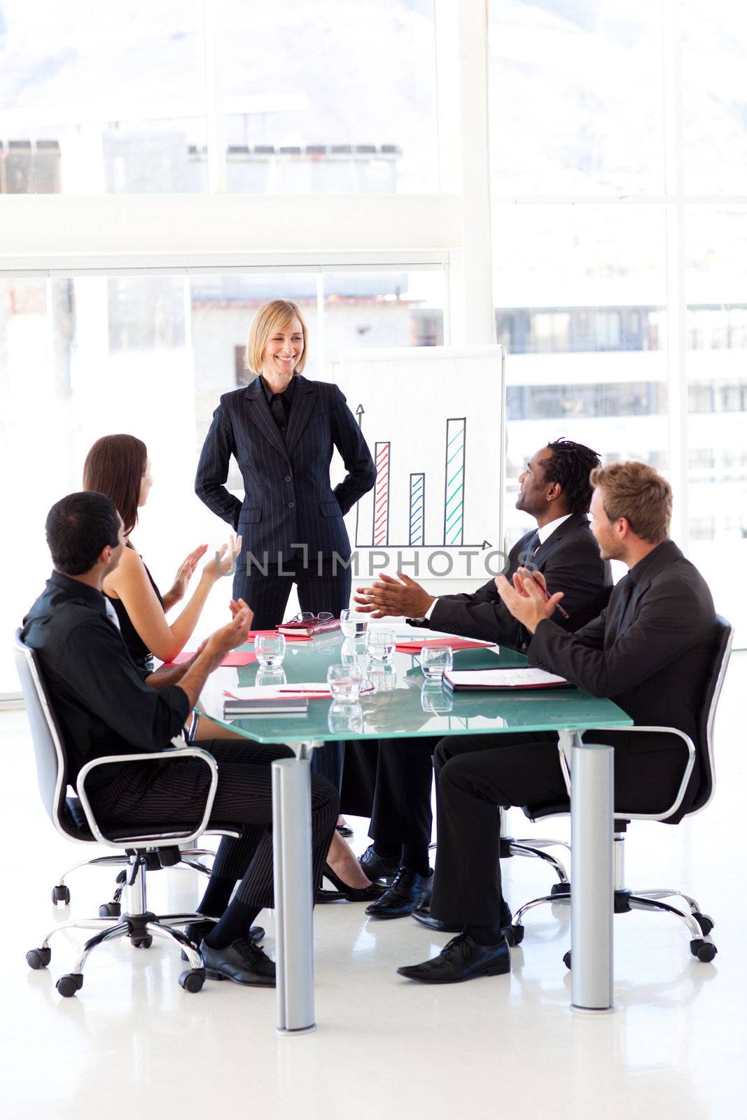 Business people clapping their manager in a meeting