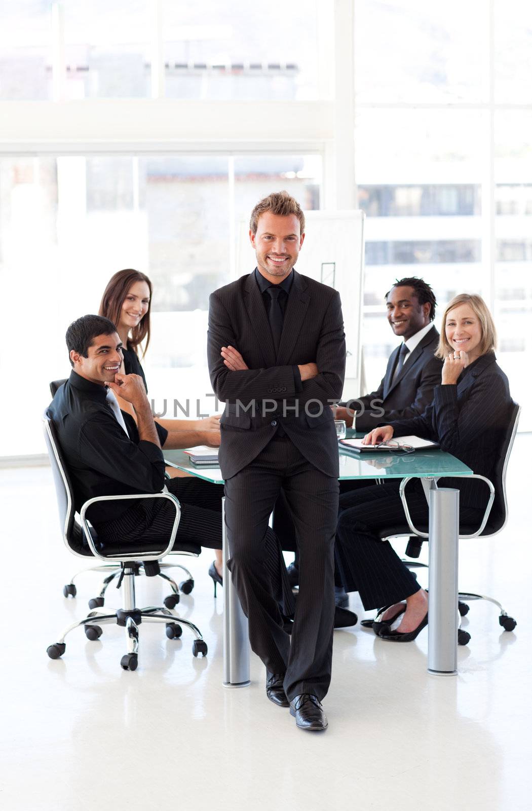 Young confident businessman with folded arms in a presentation