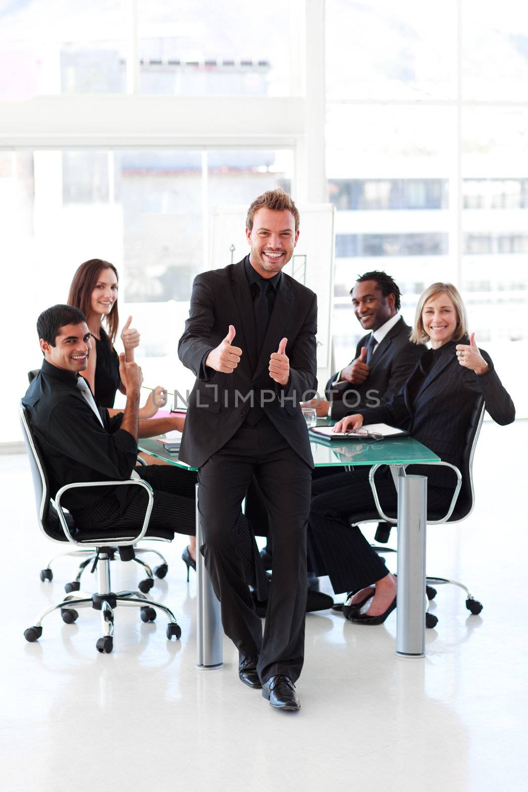Businessman with thumbs up in a meeting by Wavebreakmedia