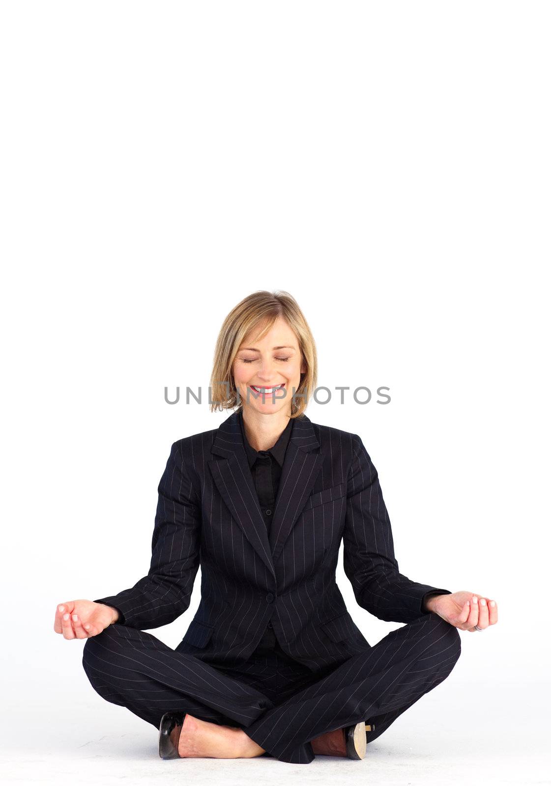 Mature businesswoman doing meditation exercises on the floor