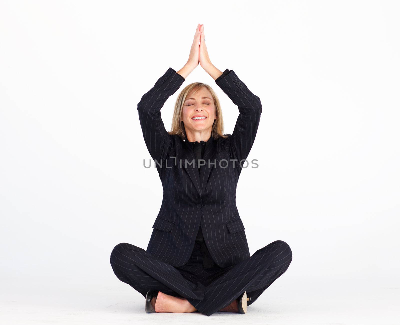 Businesswoman doing relaxation exercises on floor