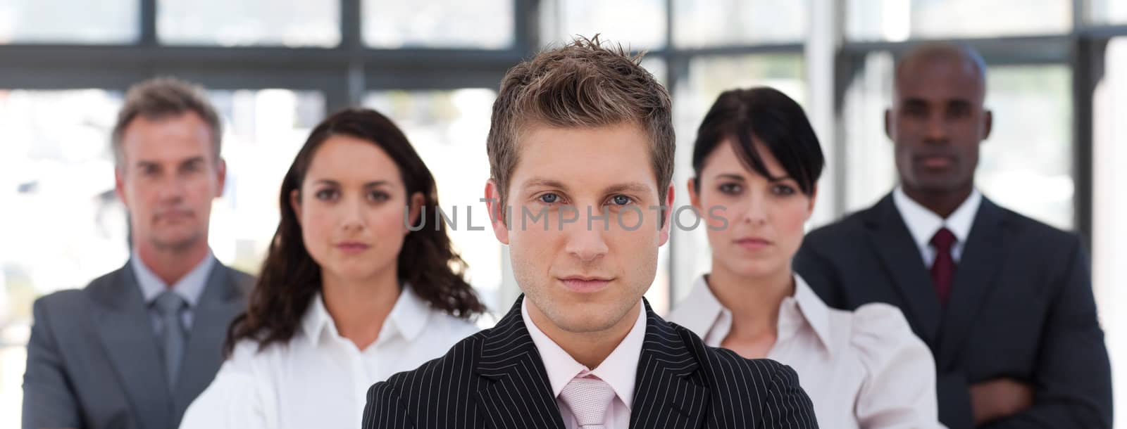 Cute business team standing together smiling at the camera 