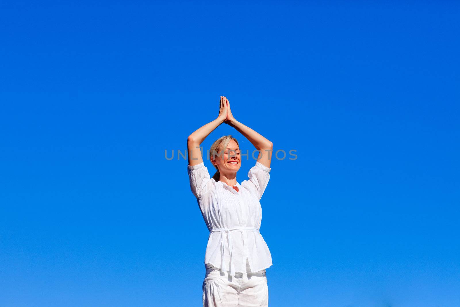 Young woman practising yoga with copy-space by Wavebreakmedia