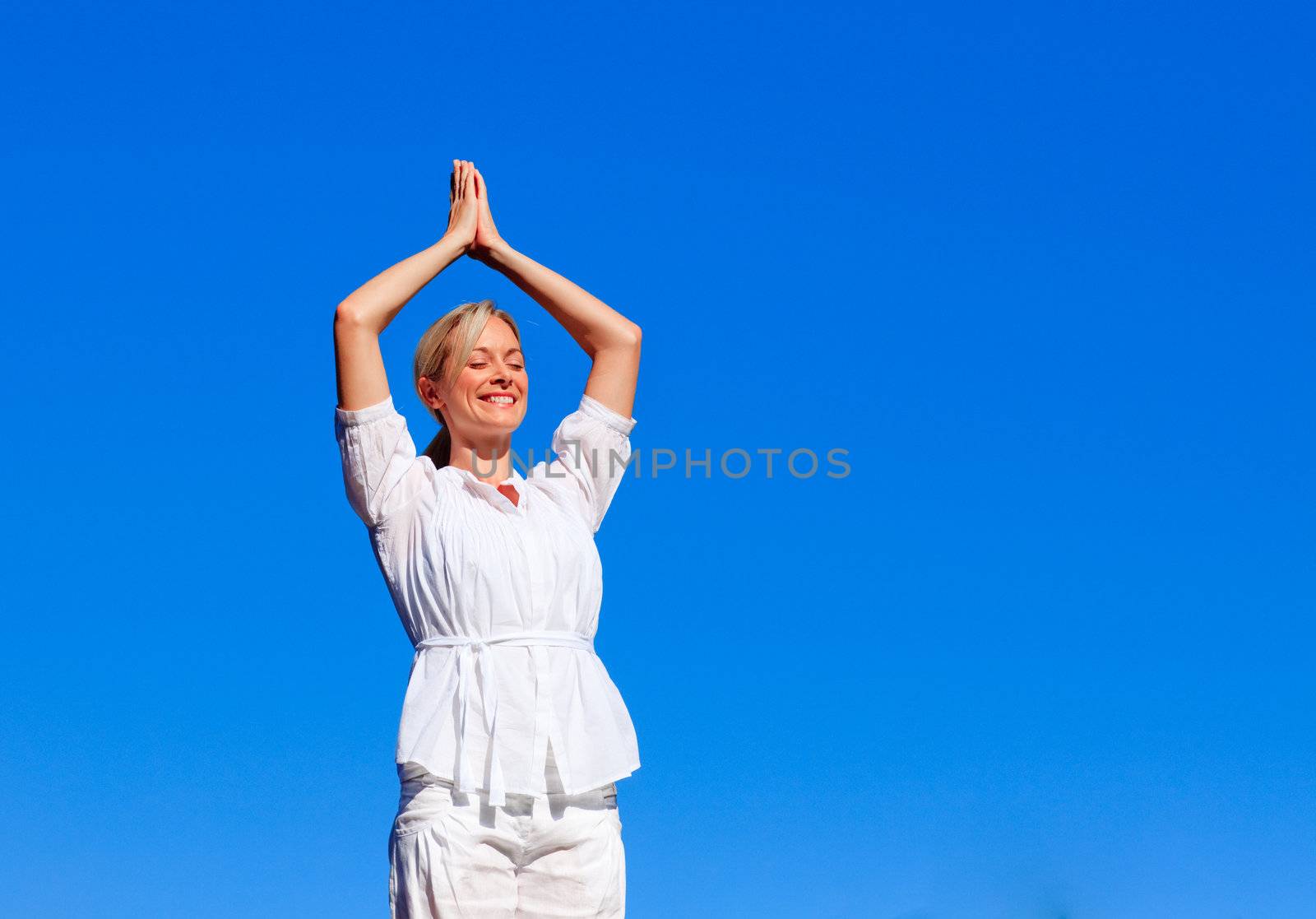 Young girl practicing yoga outdoors with copy-space