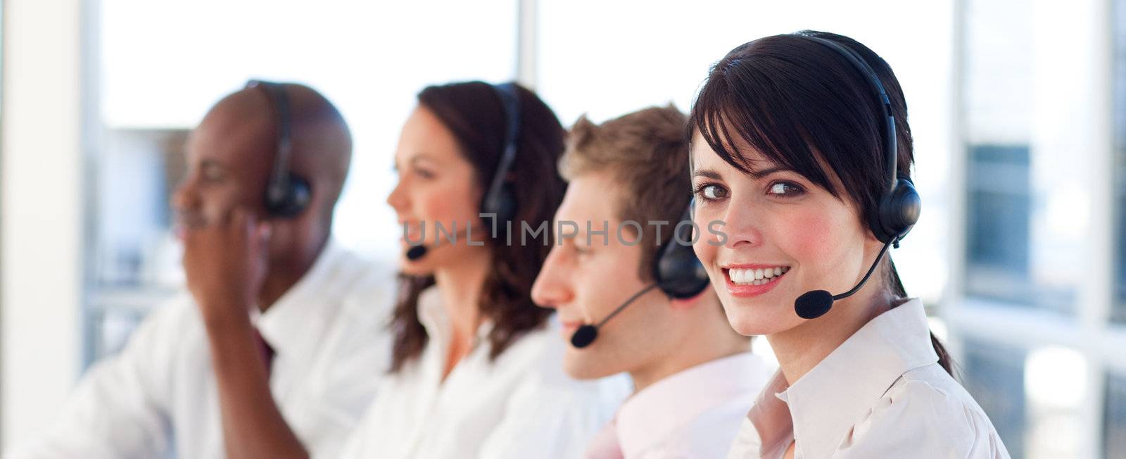 Attractive businesswoman working in a call center  by Wavebreakmedia