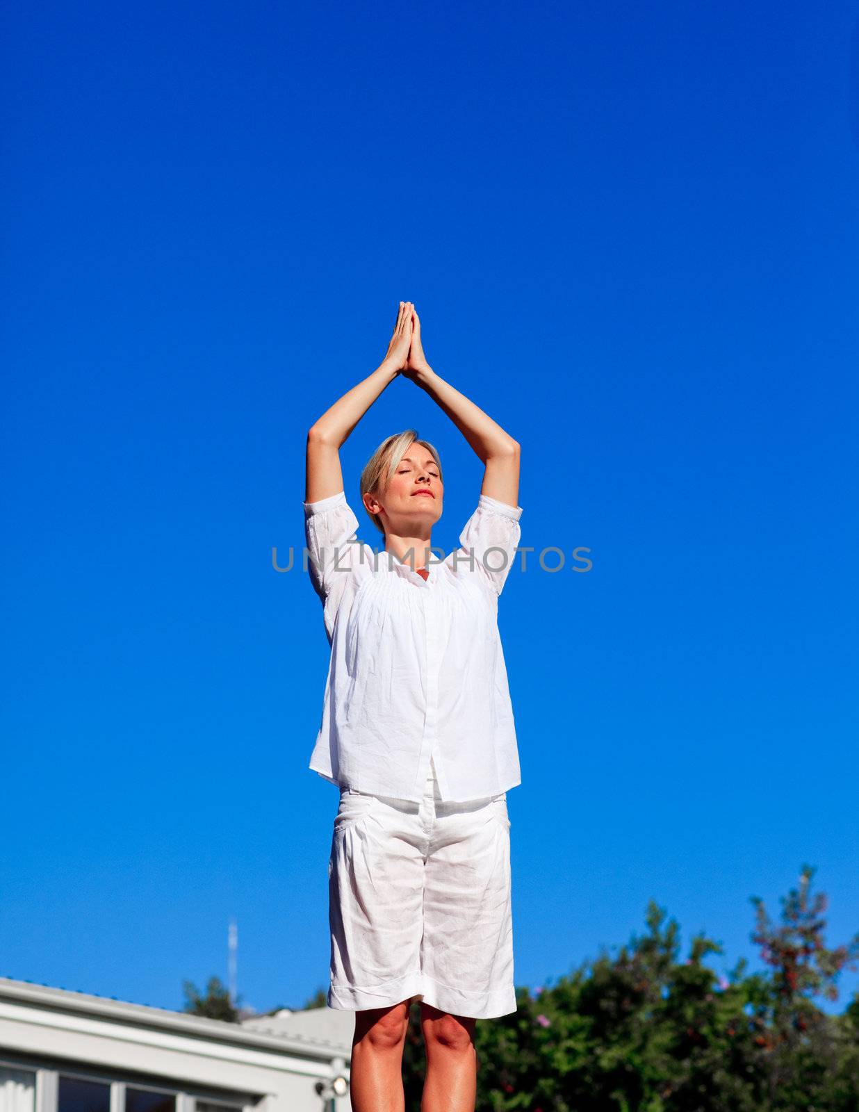 Young woman practising yoga outdoors