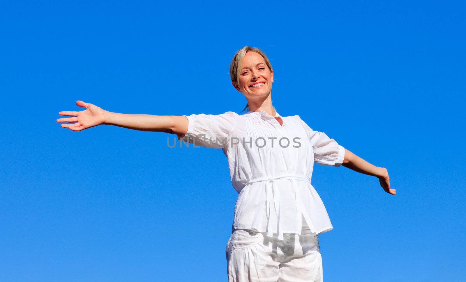 Young woman with open arms by Wavebreakmedia