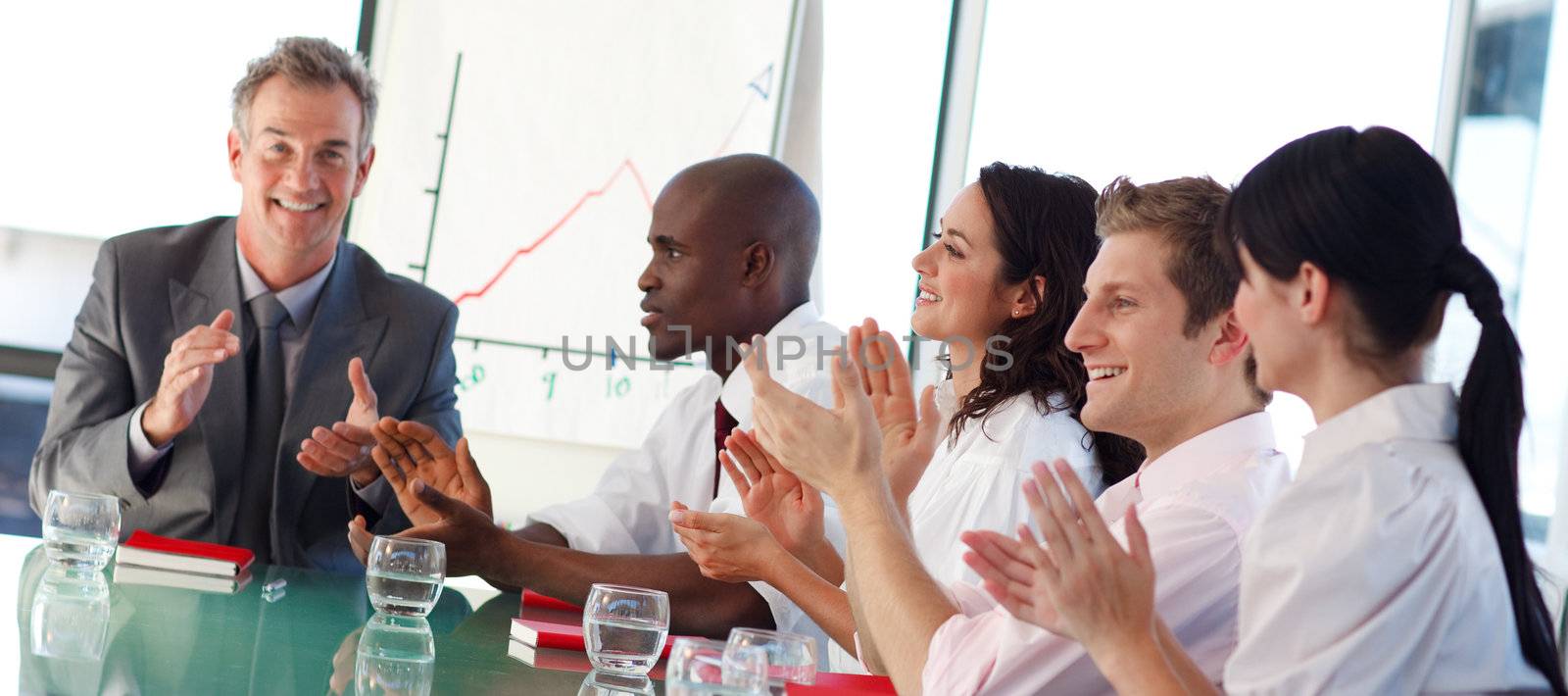International business people clapping in a meeting