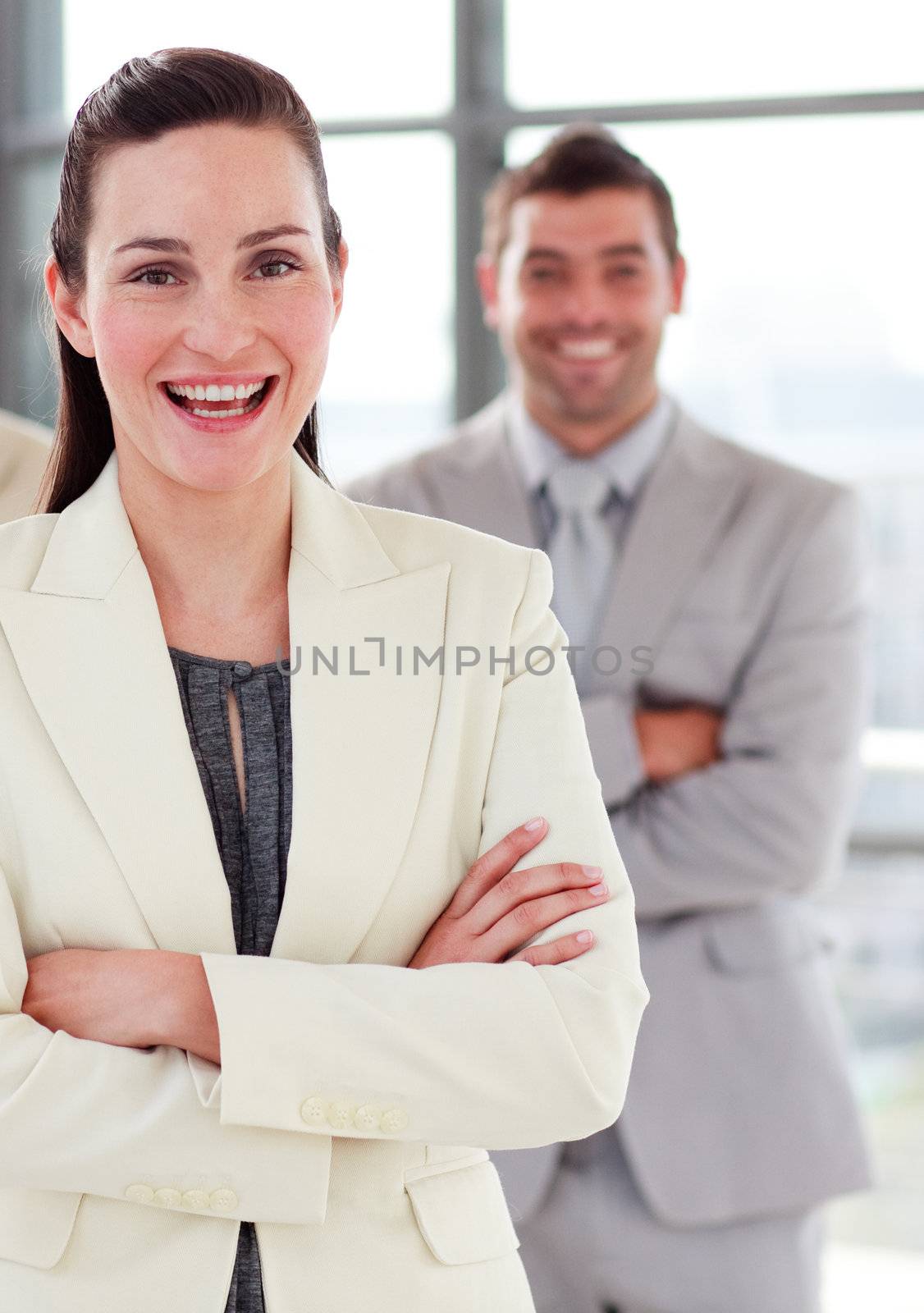 Smiling young businesswoman with folded arms