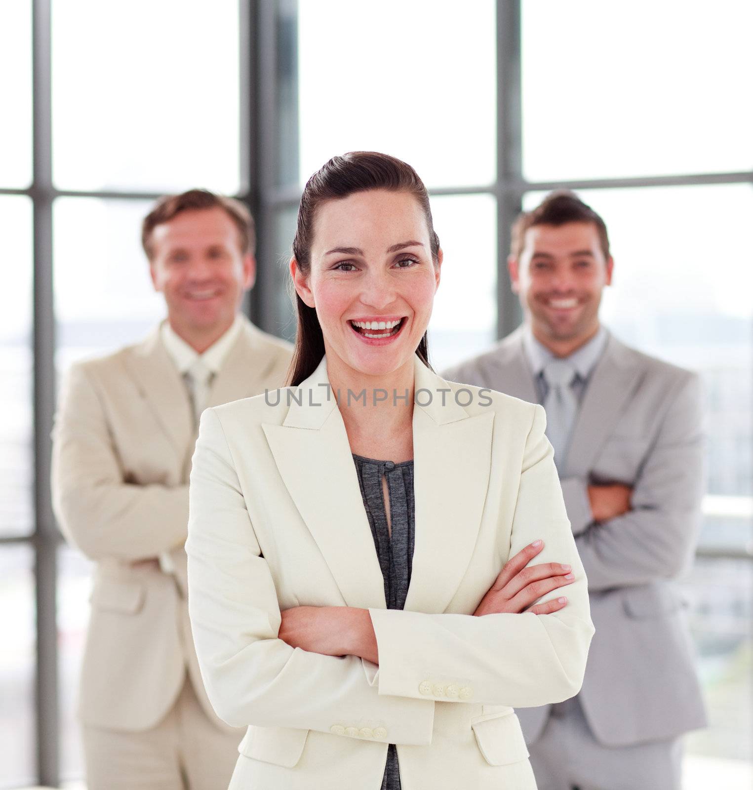 Smiling businesswoman with her team in the background by Wavebreakmedia