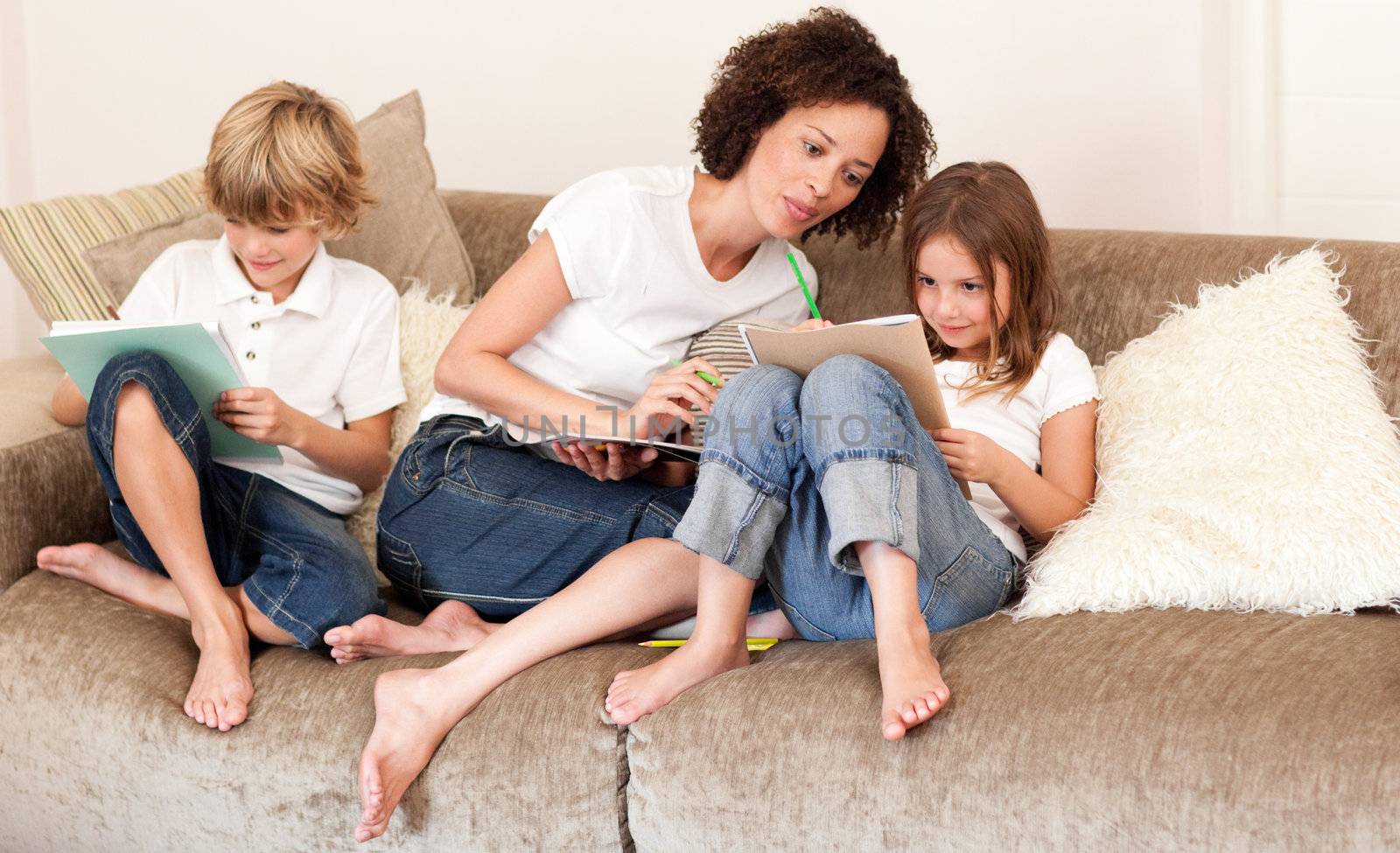 Charming family sitting on a sofa at home