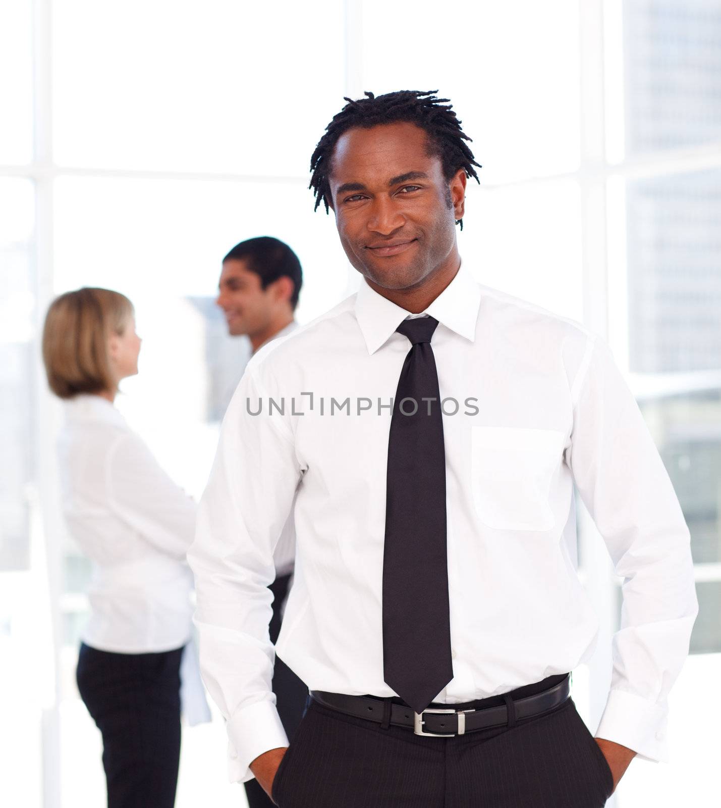 African businessman in the office with his team by Wavebreakmedia