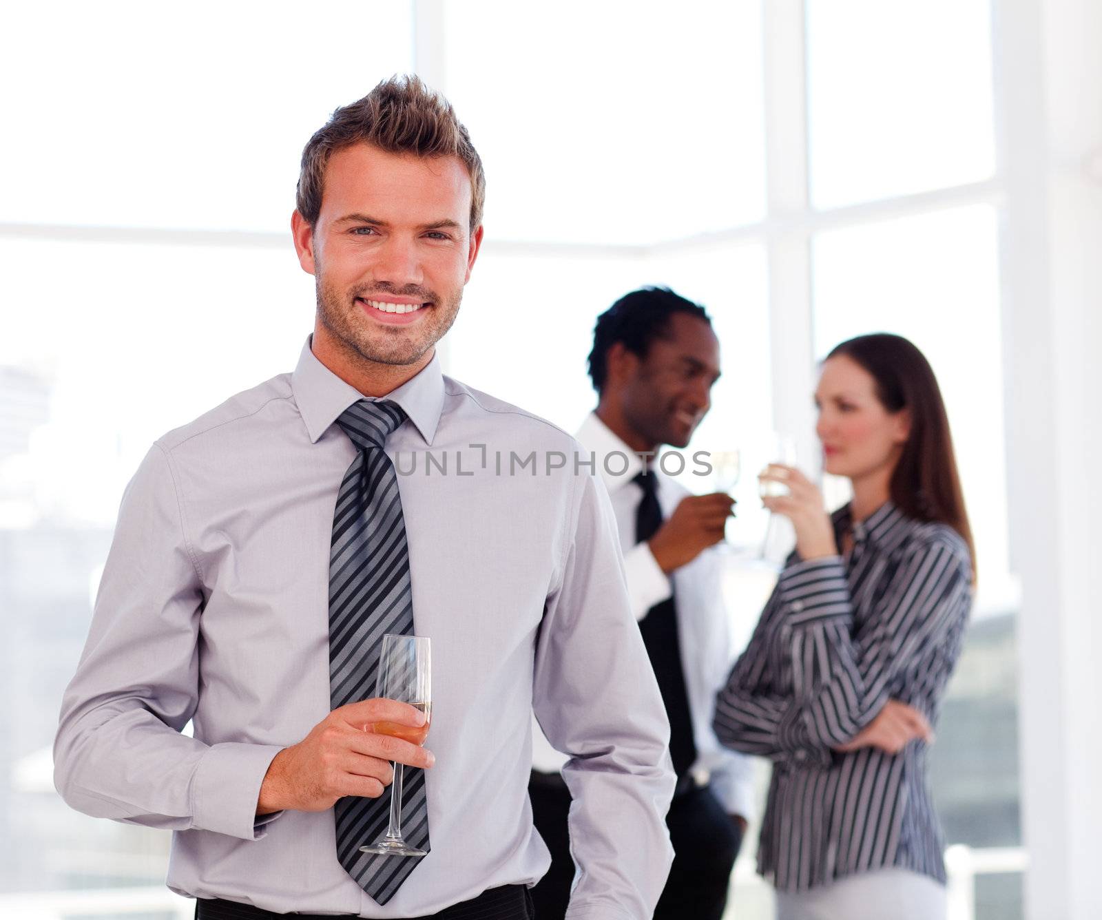 Young businessman in the office with his team by Wavebreakmedia