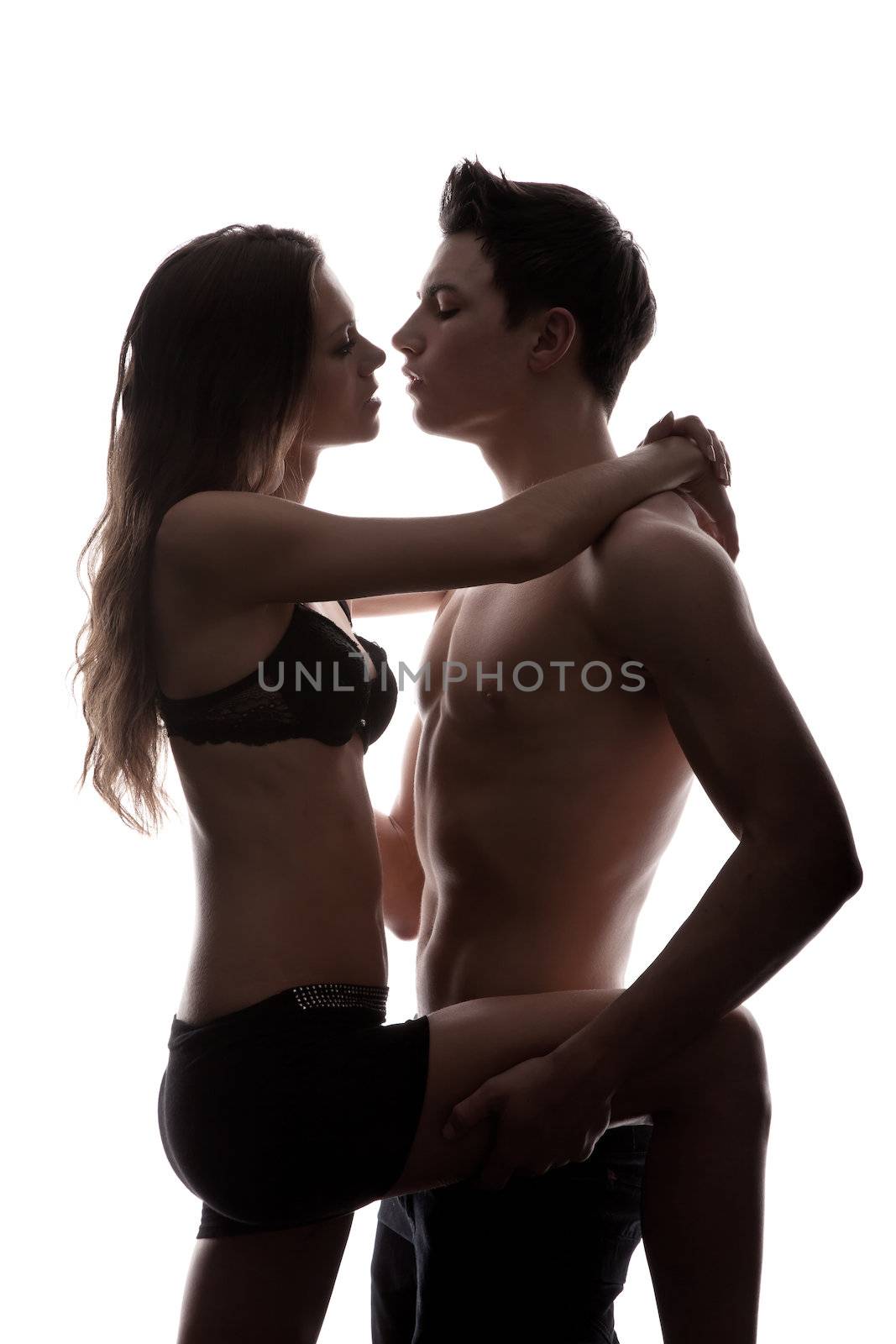 Portrait of happy young couple hugging isolated on white background