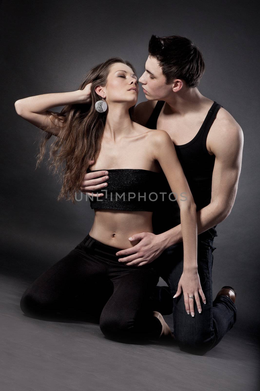 Portrait of happy young couple hugging isolated on white background